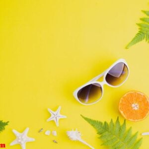 beach accessories sunglasses, starfish, orange, fern leaves and