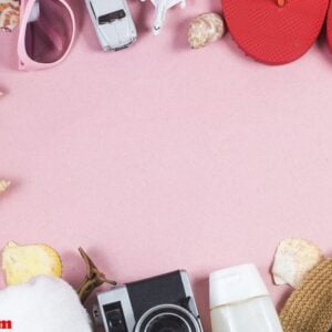 summer holiday background, travel concept with camera on pink ba