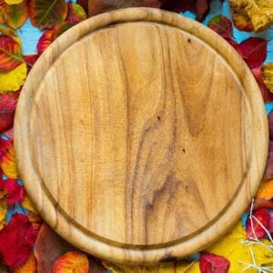 colorful autumn leaves, over a wooden background