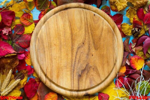 colorful autumn leaves, over a wooden background