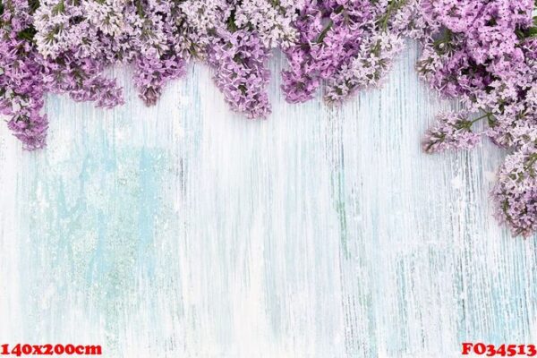 lilac flowers border on blue pastel background. top view, copy s