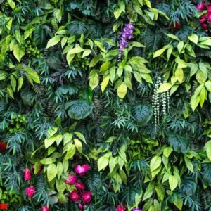 tropical leaves and flowers background. nature background of vertical garden with tropical green leaf