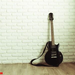 electric guitar body and neck detail on wooden background