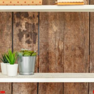 close up of white bookshelf against grunge wooden wall