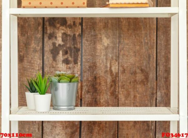 close up of white bookshelf against grunge wooden wall