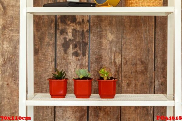 close up of white bookshelf against grunge wooden wall