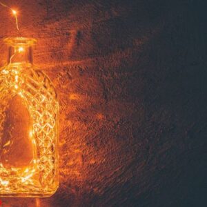 lights garland in a glass bottle on a dark background