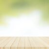 wood table top on with blur glass window wall background.