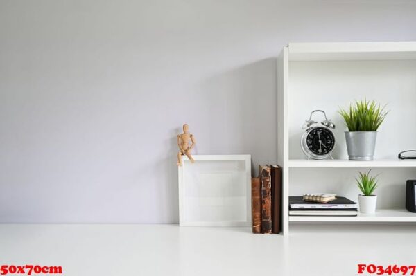 copy space with books, alarm on white table.