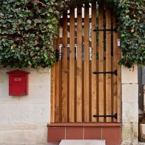 cozy wooden front door with arch from bush at the entrance of residential house