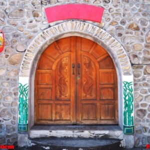 chinese wooden door style with two red lanterns.