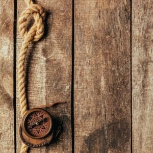 ship ropes and compass on wooden background