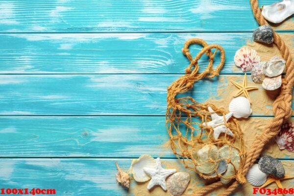 sea rope with many different sea shells on the sea sand on a blue wooden background. top view