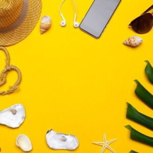 composition of beachwear and accessories on a yellow background