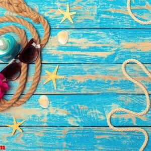 summer vacation concept of ropes, sunglasses and pink blossoms on blue wooden background