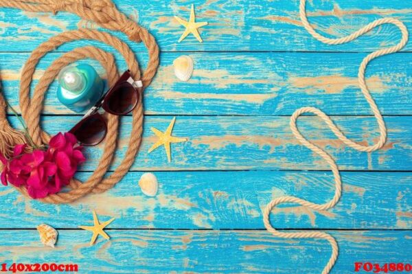 summer vacation concept of ropes, sunglasses and pink blossoms on blue wooden background