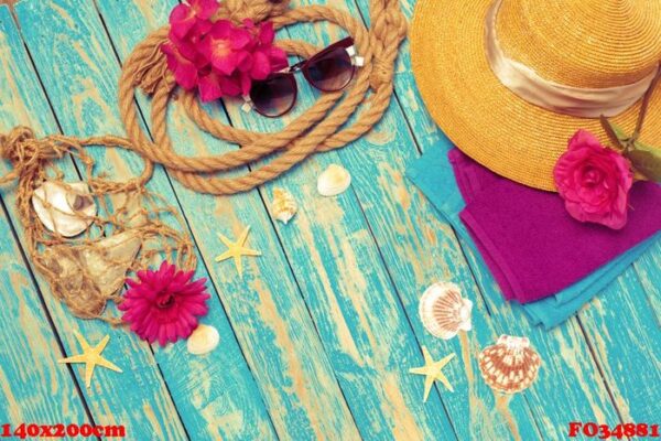 bright composition of female beach accessories on blue wooden background