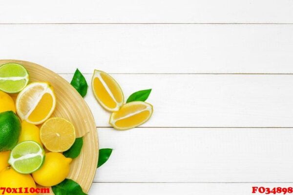 lemons and limes on a wooden background.