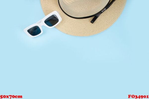 hat with sunglasses on a blue background, top view, summer conce