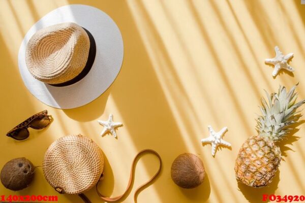 colorful summer female fashion outfit flat lay. straw hat, bamboo bag, sunglasses, coconut, pineapple, starfish over yellow background, top view. summer fashion, holiday concept