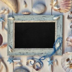 board with maritime decorations on light wood, copy space