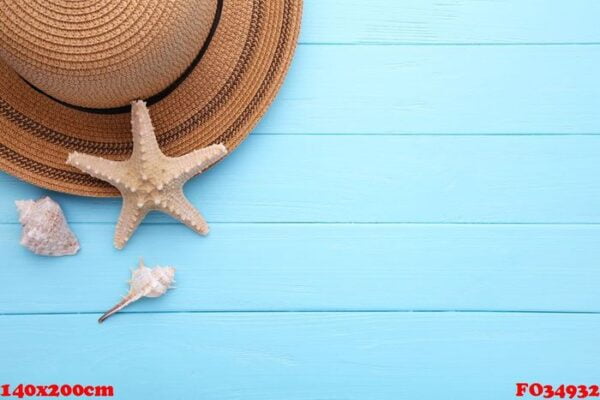 beach hat with seashells on blue wooden table