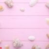 starfish and seashells on a pink wooden background. summer concept