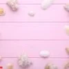 starfish and seashells on a pink wooden background. summer concept