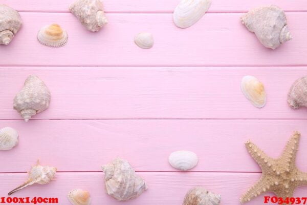 starfish and seashells on a pink wooden background. summer concept