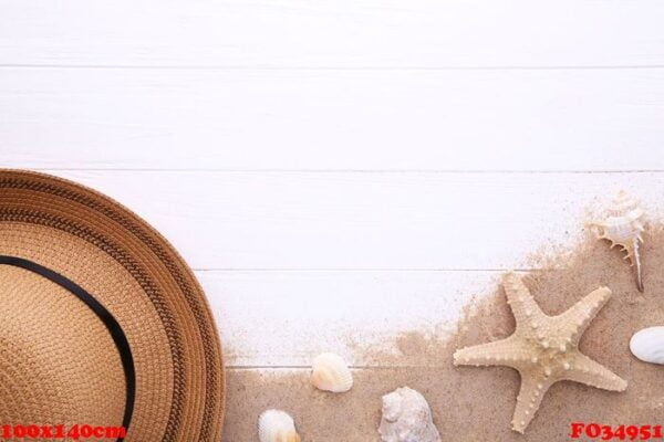 beach hat with seashells on white wooden table