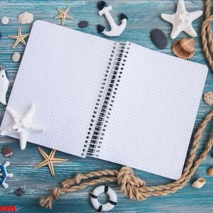 shells and notepad on wooden table