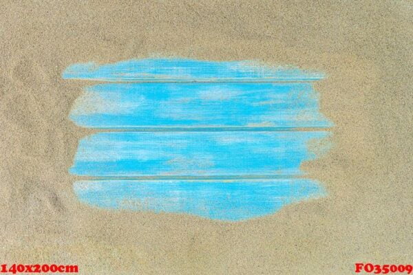 top view of beach sand with blue wooden background.