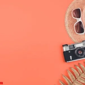 summer flat lay with copy space on coral background. old retro d