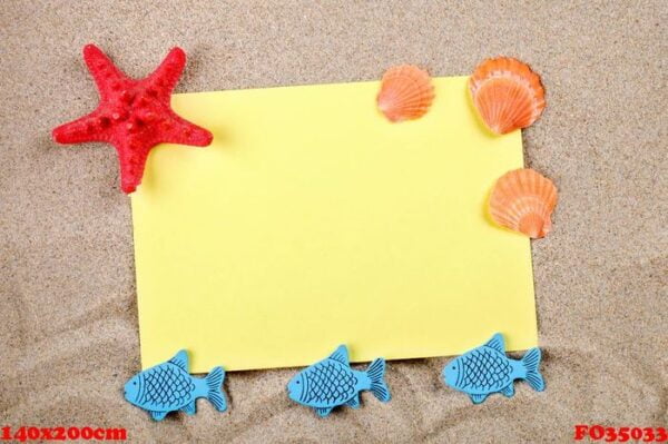 starfish and seashells lying on the sand on the postcard.