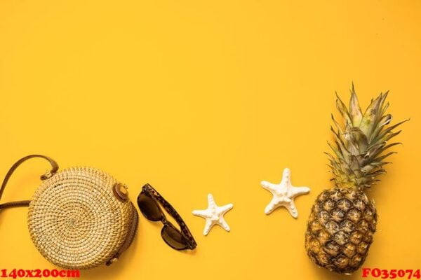 colorful summer female fashion outfit flat lay. bamboo bag, sunglasses, pineapple and starfish over yellow background, top view. summer fashion, holiday concept