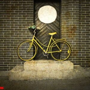 vintage retro old yellow bike on the street.