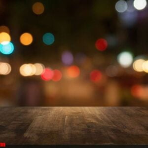 empty dark wooden table in front of abstract blurred background