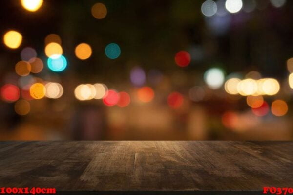 empty dark wooden table in front of abstract blurred background