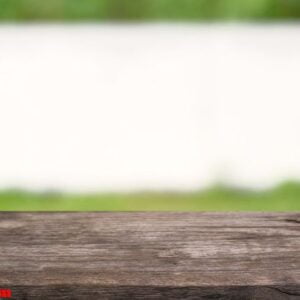 empty wooden table in front of abstract blurred background of co