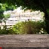 empty dark wooden table in front of abstract blurred background