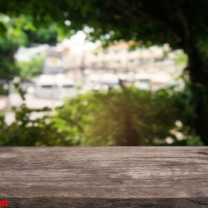 empty dark wooden table in front of abstract blurred background