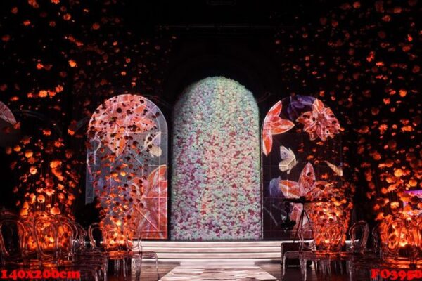 glance path leads to bright archs with flowers in dark room