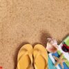 beach background with flip flops and sunglasses