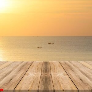 vintage wooden board empty table in front of sunset background.