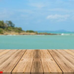 vintage wooden board empty table in front of blue sea & sky back