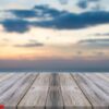 vintage wooden board empty table in front of sunset background.