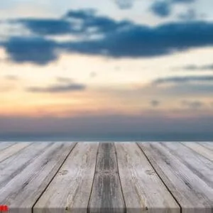 vintage wooden board empty table in front of sunset background.