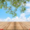 vintage wooden board empty table in front of blue sea & sky back