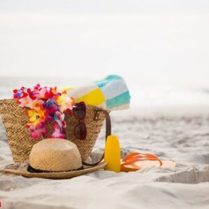 bag with beach accessories kept on sand