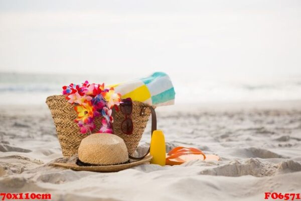 bag with beach accessories kept on sand